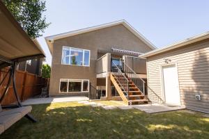 a house with a staircase in front of it at Opulent Oasis in Lethbridge