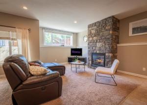 a living room with a couch and a fireplace at Opulent Oasis in Lethbridge