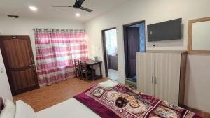 a bedroom with a bed and a television in a room at Himalayan Haven in Srinagar