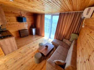 a living room with a couch and a table at Close to the sky in Agara