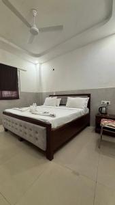 a bedroom with a large bed in a room at Hotel M Palace Unit Of MDP Ayodhya Near Rammandir in Ayodhya +25 photos