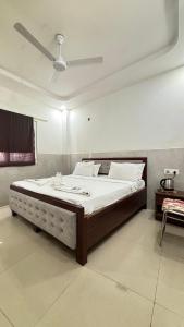 a bedroom with a large bed with a sink at Hotel M Palace Unit Of MDP Ayodhya Near Rammandir in Ayodhya