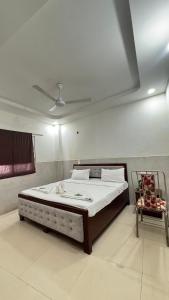 a bedroom with a large bed in a room at Hotel M Palace Unit Of MDP Ayodhya Near Rammandir in Ayodhya