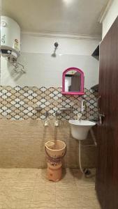 a bathroom with a toilet and a sink at Hotel M Palace Unit Of MDP Ayodhya Near Rammandir in Ayodhya