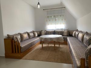 a living room with a couch and a table at Cedar Peak Residence in Ifrane