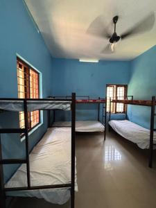 a room with three bunk beds and a ceiling at CK Enclave in Jāmb