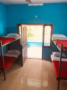 a room with a door open to a room with bunk beds at CK Enclave in Jāmb
