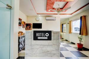 a hotel lobby with a hotel sign on the wall at Super OYO Hotel O Khargapur Ring Road Formerly Shimla Grand in Lucknow