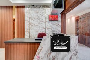a restaurant with a counter with a sign on it at Super Collection O AIIMS Bhubaneshwar in Khandagiri