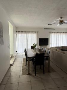 a living room with a table and chairs and a couch at Tide's End in Langstrand