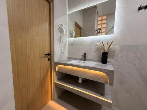 a bathroom with a sink and a mirror at Keremet Hotel in Almaty +49 photos
