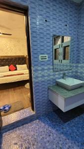 a bathroom with a sink and a mirror and a bed at Himalayan Haven in Srinagar +38 photos