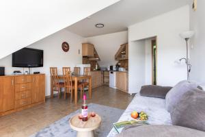 a living room with a couch and a table at Dollár Apartman in Orfű