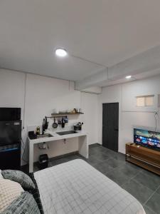 a room with a kitchen and a bed and a tv at Freya Studio I Romantic Zone in Puerto Vallarta