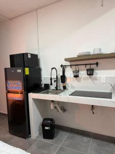 a kitchen with a sink and a stove and a refrigerator at Freya Studio I Romantic Zone in Puerto Vallarta +6 photos