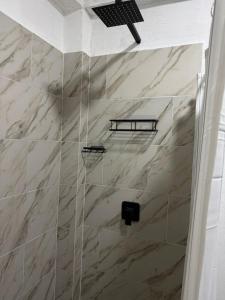 a bathroom with a shower with marble tiles at Freya Studio I Romantic Zone in Puerto Vallarta
