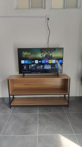 a flat screen tv sitting on top of a wooden entertainment center at Freya Studio I Romantic Zone in Puerto Vallarta