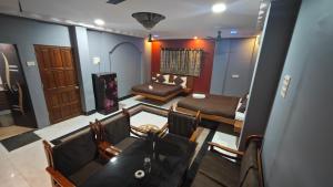 a dining room with a table and chairs and a room at Redwing Peaceful Studio in Navi Mumbai