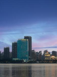 a view of a city skyline with the water at Shangri-La Nanchang丨Adjacent to Pavilion Prince Teng Prime river view in Nanchang