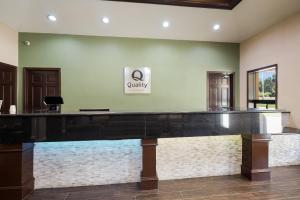 an empty lobby with a large aquarium in the center at Quality Inn & Suites Lufkin in Lufkin +28 photos