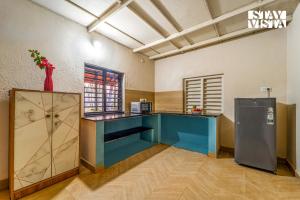 a kitchen with a blue counter in a room at StayVista at Jungle Jade with WiFi in Madikeri