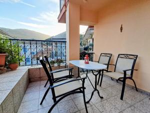 a patio with a table and chairs on a balcony at Parga Center Apartment in Parga