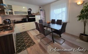 a kitchen and dining room with a table and chairs at Apartment Andy in Medvode