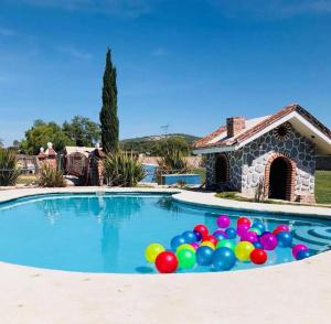 a pool filled with colorful balloons in front of a house at Casa Jardín Santiago in Texcoco de Mora
