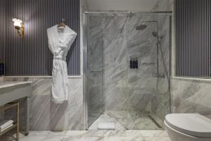 a bathroom with a shower and a toilet at Palazzo Donizetti Istanbul, Tapestry Collection by Hilton in Istanbul