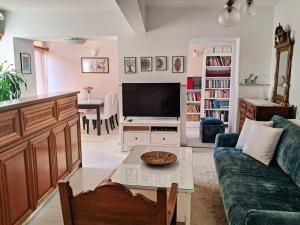a living room with a couch and a tv at Parga Center Apartment in Parga