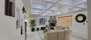 a living room with two couches and a tv at Cabañas Privadas San Carlos Escape & Relax in Ensenada