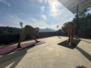 two people doing yoga on mats on a roof at Bethel Ella in Ella
