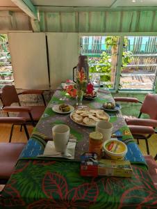 a table with a plate of food on it at Lamkail beach island bungalow in Lénakel +10 photos