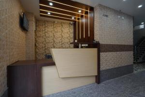 a lobby with a reception desk with a sign on it at Golden Comforts Banglore in Bangalore