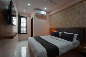 a bedroom with a large bed and a wall at Golden Comforts Banglore in Bangalore