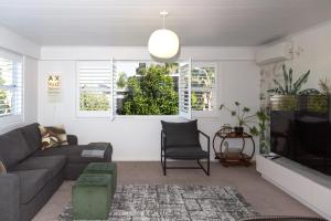 a living room with a couch and a tv at Townhouse on Courtenay in New Plymouth