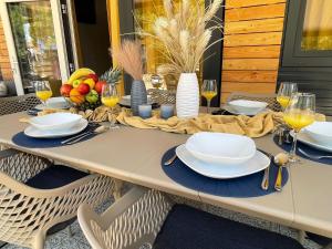 a table with plates and wine glasses on it at Mobile Home River in Privlaka
