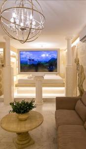 a living room with a couch and a large tv at CENTAURIA Greek Luxury Suite 5' Port Gate 7-8 & Cruises Gate 11-12 in Piraeus