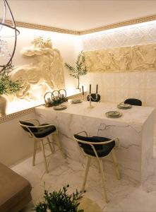 a kitchen with a marble counter with two chairs at CENTAURIA Greek Luxury Suite 5' Port Gate 7-8 & Cruises Gate 11-12 in Piraeus