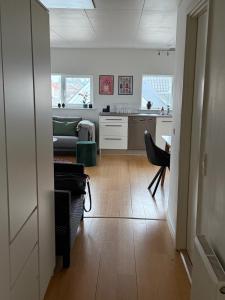 a kitchen and living room with a couch and a table at Kystvejen Øster Hurup in Hadsund