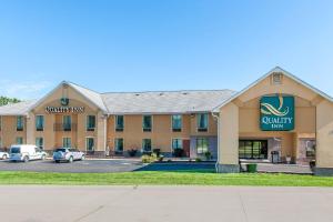 a hotel front of a building with cars parked at Quality Inn Bloomington Near University in Bloomington