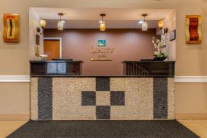 a lobby with a counter with auryy sign on the wall at Quality Inn Bloomington Near University in Bloomington +35 photos