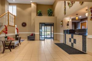 a lobby of a hospital with a staircase and a waiting room at Quality Inn Bloomington Near University in Bloomington