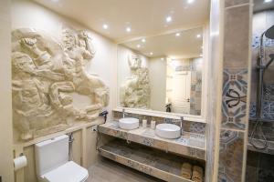 a bathroom with statues on the wall and a toilet at CENTAURIA Greek Luxury Suite 5' Port Gate 7-8 & Cruises Gate 11-12 in Piraeus