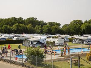 a group of people standing around a pool at a campground at DCU-Camping Odense in Odense