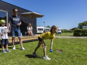 a group of people playing with a ball in a yard at DCU-Camping Odense in Odense +1 photo