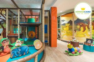 a childs play area with a play set and a play set track at Familienhotel Löwen in Nesselwang