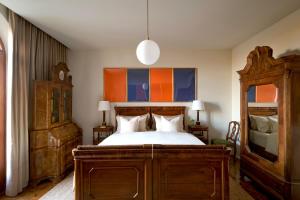 a bedroom with a large wooden bed and a dresser at La Giardina Guest House in Chieri