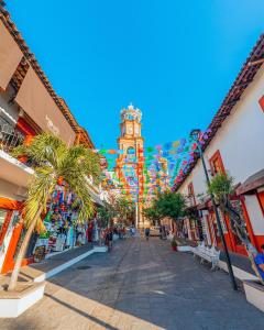 a city street with a clock tower in the background at Freya studio III Romantic Zone in Puerto Vallarta