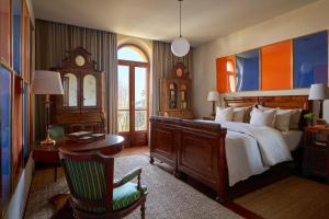 a bedroom with a bed and a desk and a chair at La Giardina Guest House in Chieri